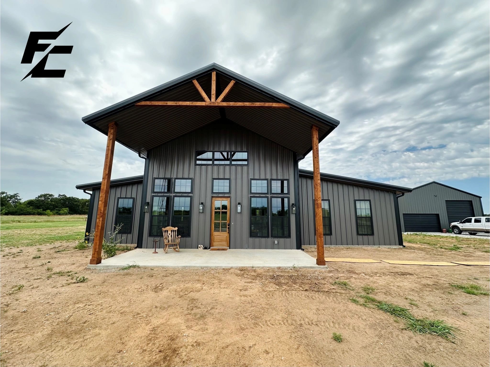 A completed Fine Cut barndominium with timber-framed entry