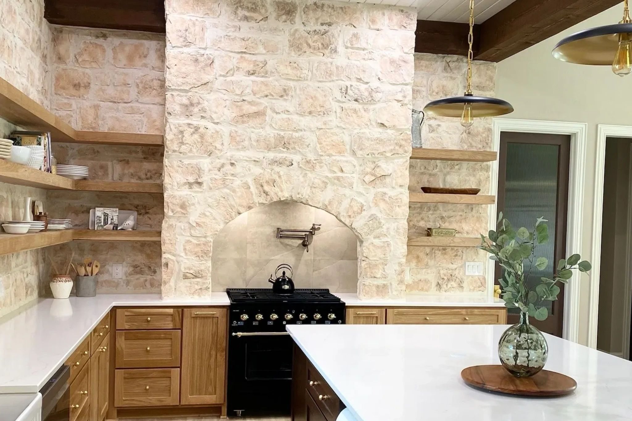 Kitchen with stone hearth and open shelving