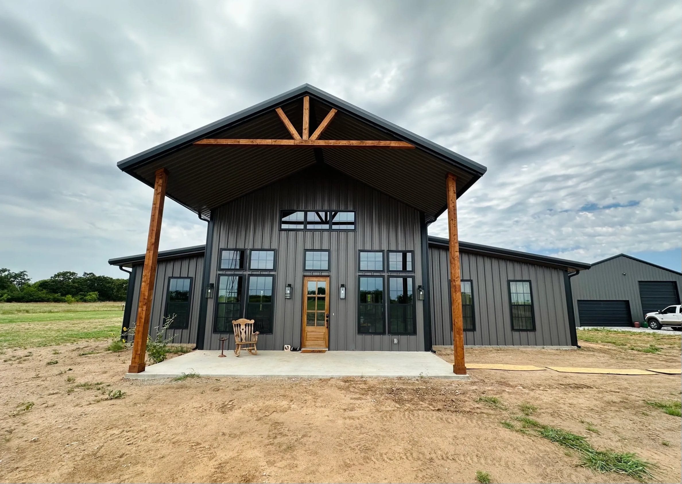 A finished Fine Cut barndominium with metal roof and covered porch